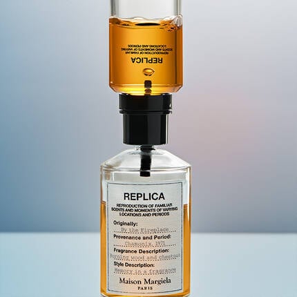 A bottle of Replica perfume being refilled