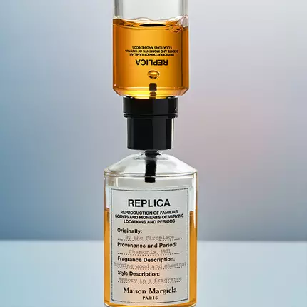 A bottle of Replica perfume being refilled